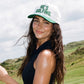 He's Golfing Trucker Hat