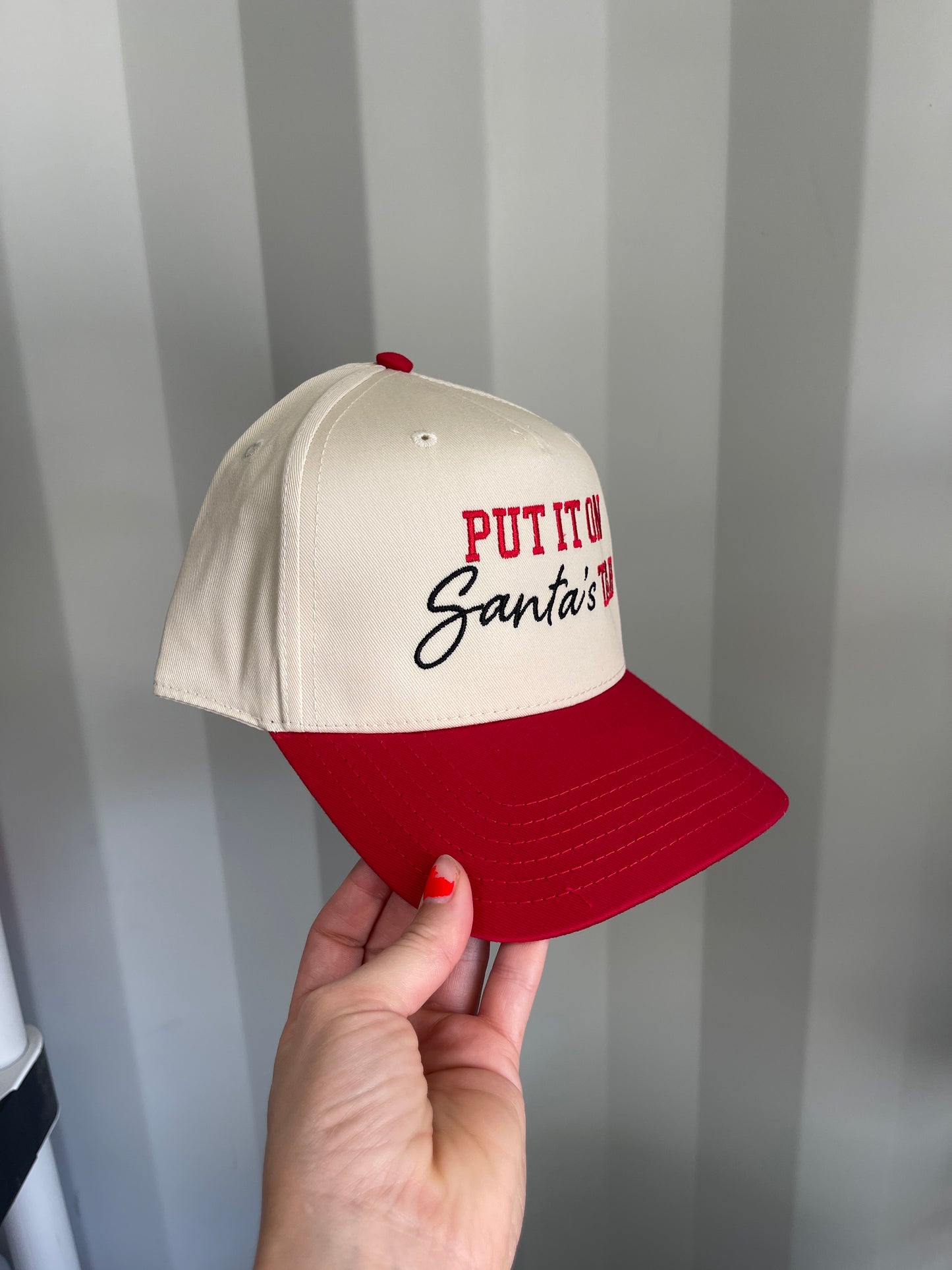 Put it on Santa’s tab Trucker Hat