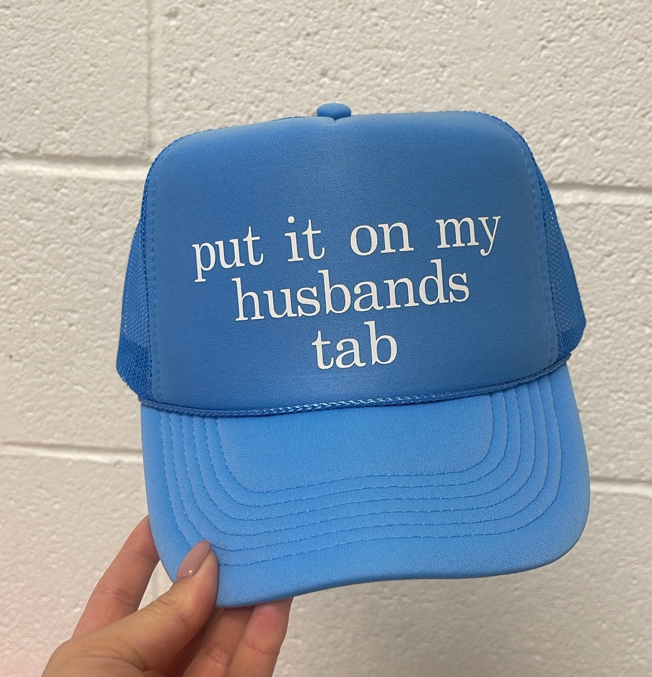 Put it on my husbands tab Trucker Hat