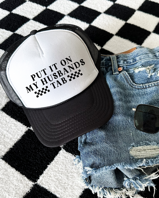 Put It On My Husbands Tab Trucker Hat